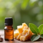 a-small-glass-bottle-of-frankincense-essential-oil-next-to-frankincense-resin-and-green-leaves-on-a-wooden-table-